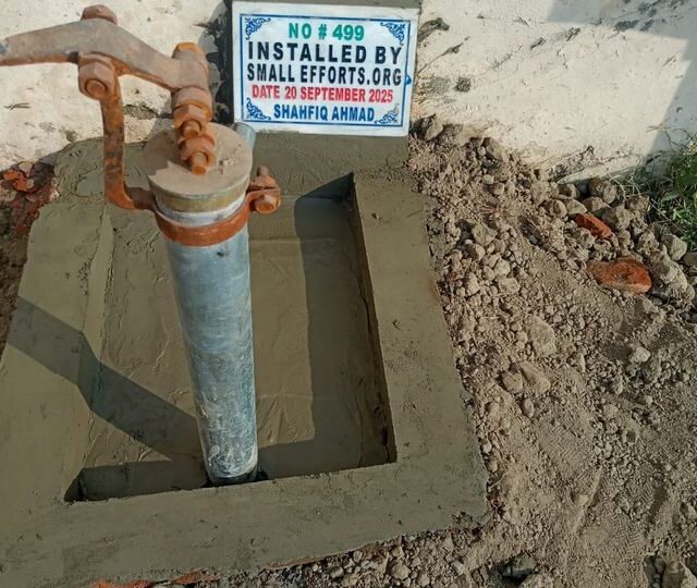 A completed hand pump carrying the Trust's installation plaque