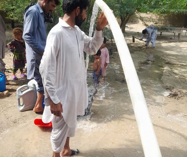Water running from a new well in Dera Ghazi Khan